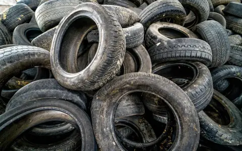 Stare opony czekają na nowe życie. Zastanawiasz się, co zrobić ze starymi oponami? Oto stos używanych opon samochodowych, gotowych do recyklingu lub kreatywnego wykorzystania.